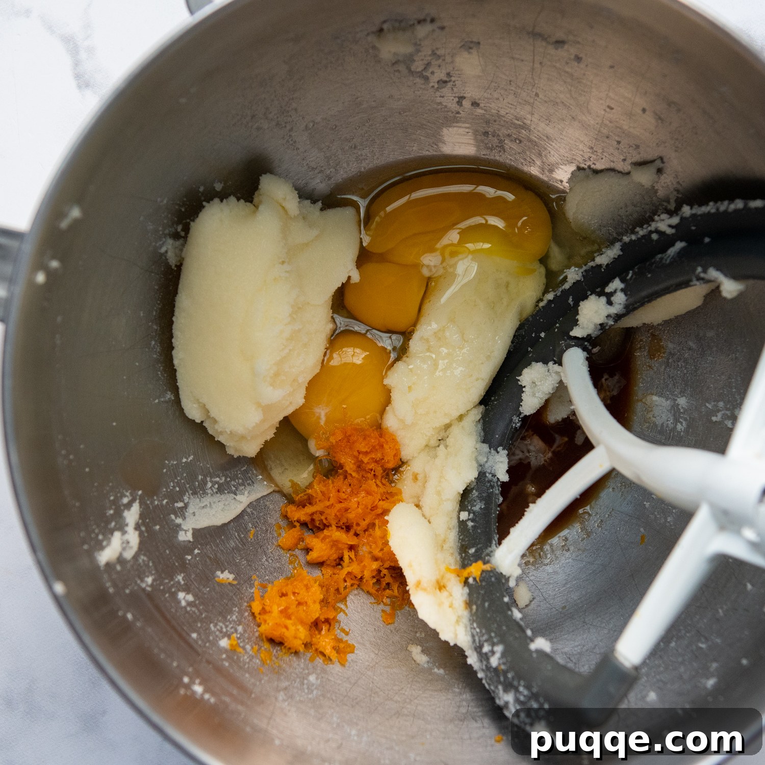 Feather-Light, Perfectly Crispy Gluten-Free Biscotti 3 A close-up shot of the creamed butter and sugar mixture, glistening with freshly incorporated eggs and vibrant orange zest, ready for the next stage of baking.