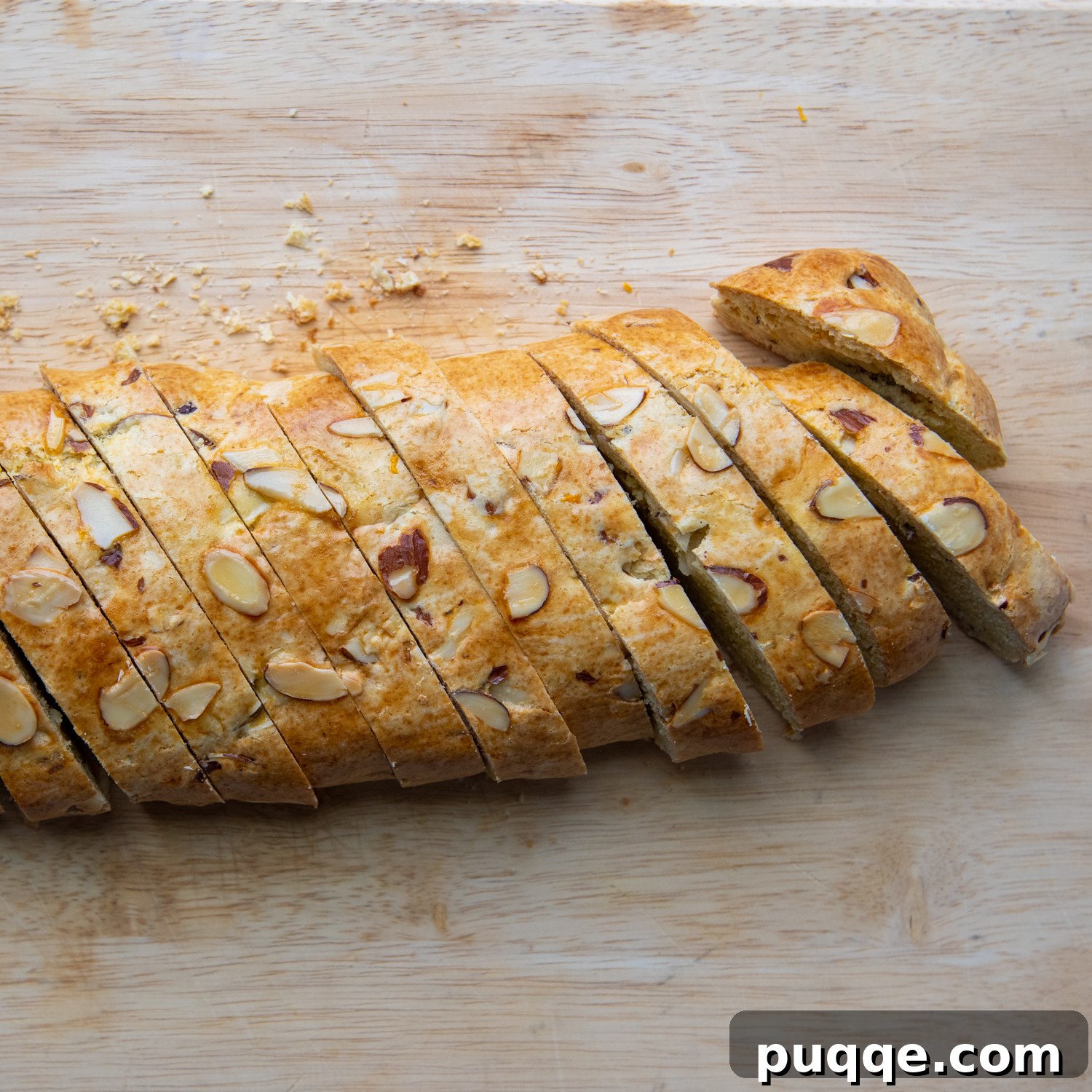 Feather-Light, Perfectly Crispy Gluten-Free Biscotti 6 Freshly baked biscotti logs, perfectly sliced on the diagonal and arranged on a baking sheet, eagerly awaiting their second bake to achieve ultimate crispness.