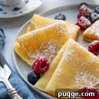 close up of folded plates with berries scattered around
