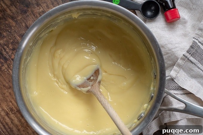 Close-up shot of creamy vanilla custard in a saucepan, ready for cooling.
