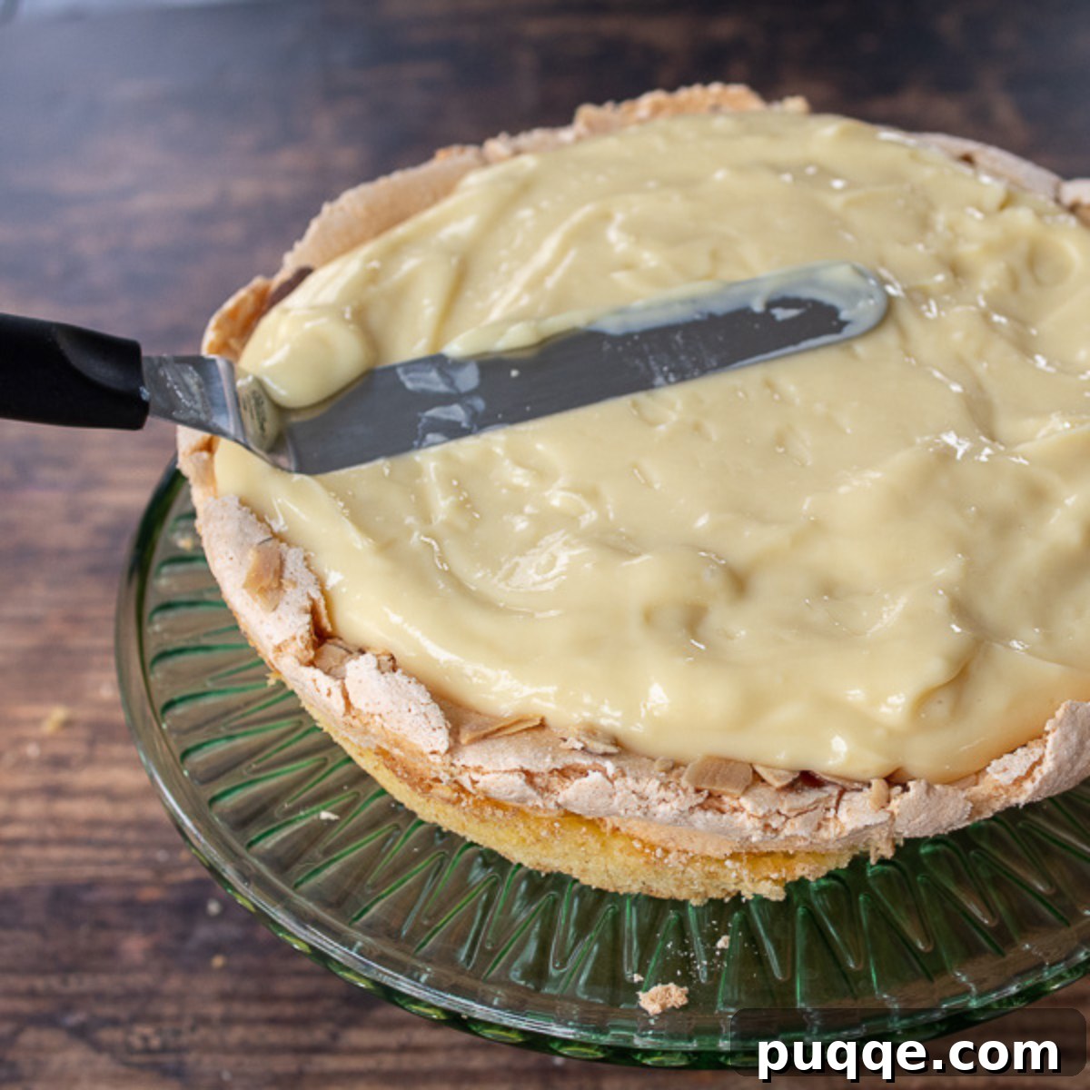 A smooth, creamy layer of vanilla custard spread over the first cake layer of the Blitz Torte.