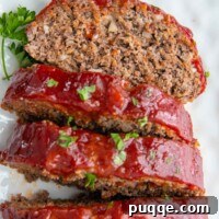 Juicy Gluten-Free Meatloaf: A Taste of Home Comfort 8 A slice of juicy gluten-free meatloaf with a golden glaze, resting on a white plate.