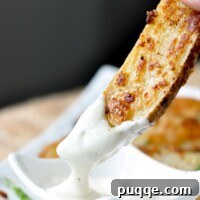 A roasted ranch potato being dipped into ranch dressing, ready to be enjoyed.