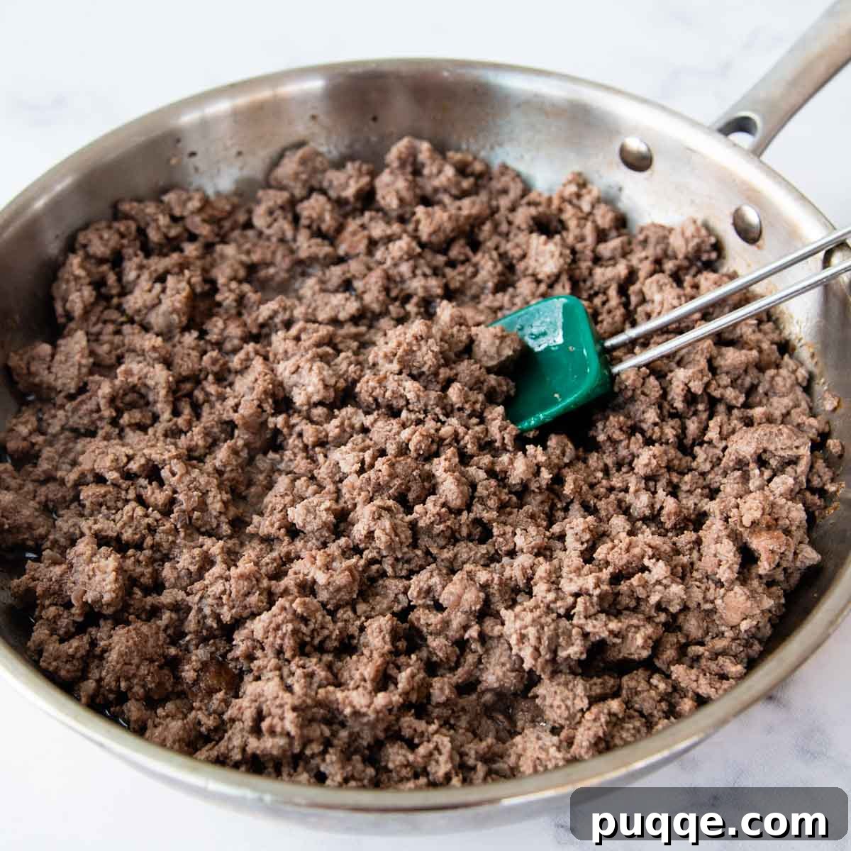 Golden Tater Tot Sloppy Joe Bake 4 Ground beef browning in a large skillet over medium-high heat, breaking into crumbles.
