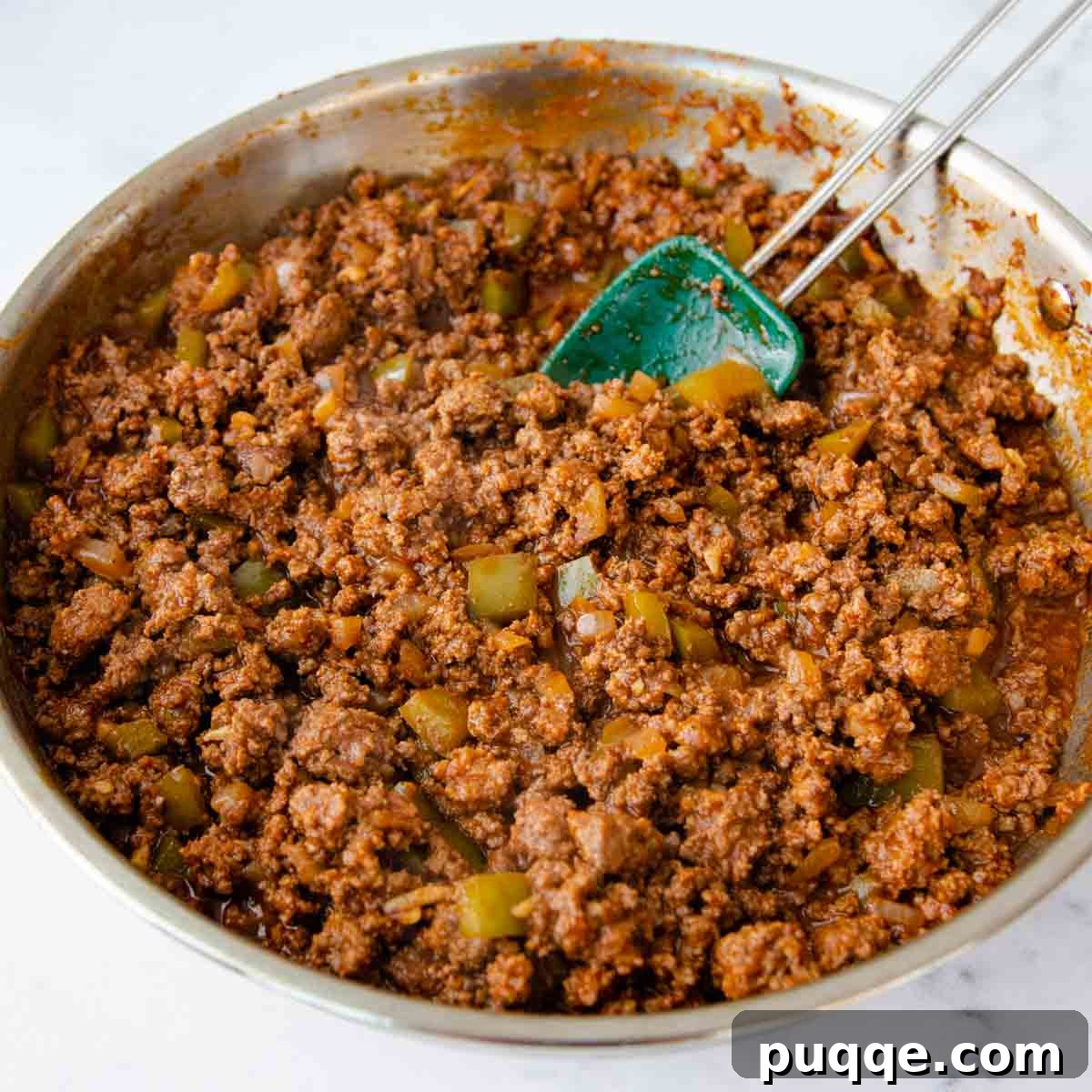 Golden Tater Tot Sloppy Joe Bake 6 A rich, tangy sloppy joe ground beef mixture simmering in a skillet, blending all the sauce ingredients.