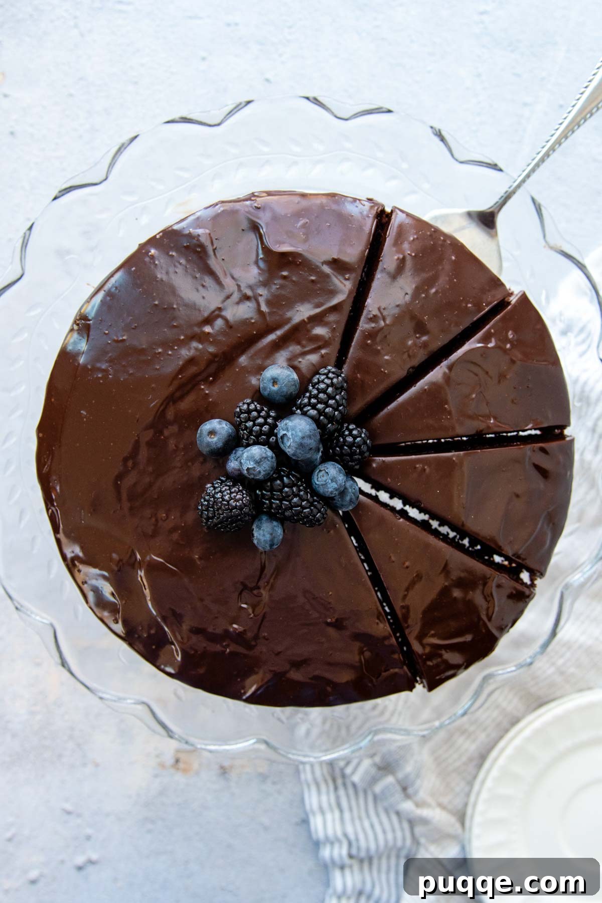 Decadent Almond Flour Chocolate Cake 5 overhead shot of cake covered in ganache with berries on top