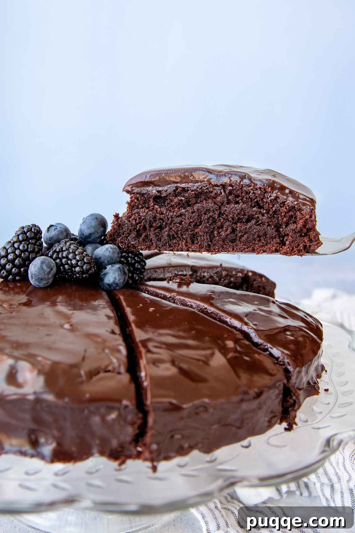 Decadent Almond Flour Chocolate Cake 6 a slice of cake being lifted out with a spatula