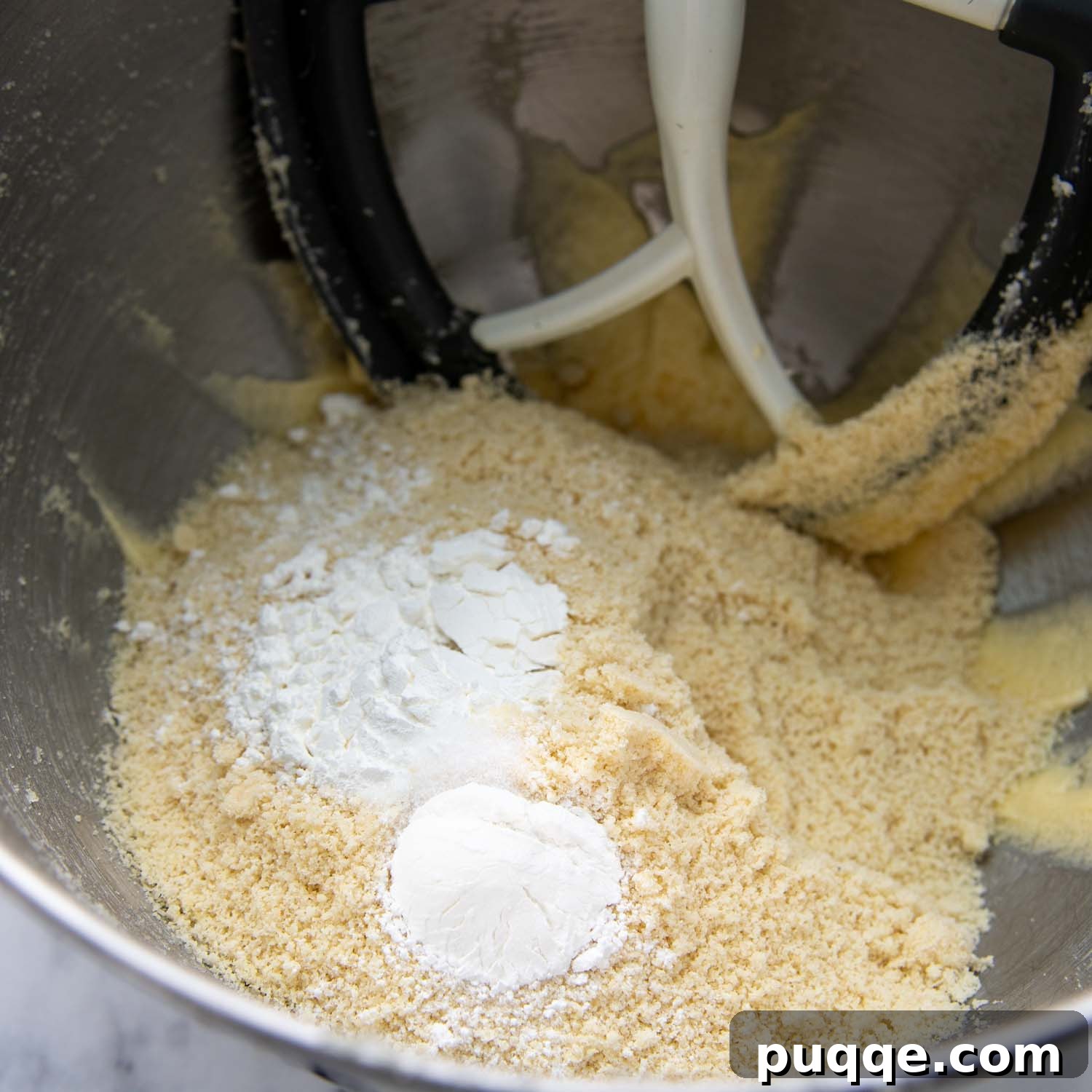 Ingredients for biscotti dough in a mixing bowl, ready to be combined.