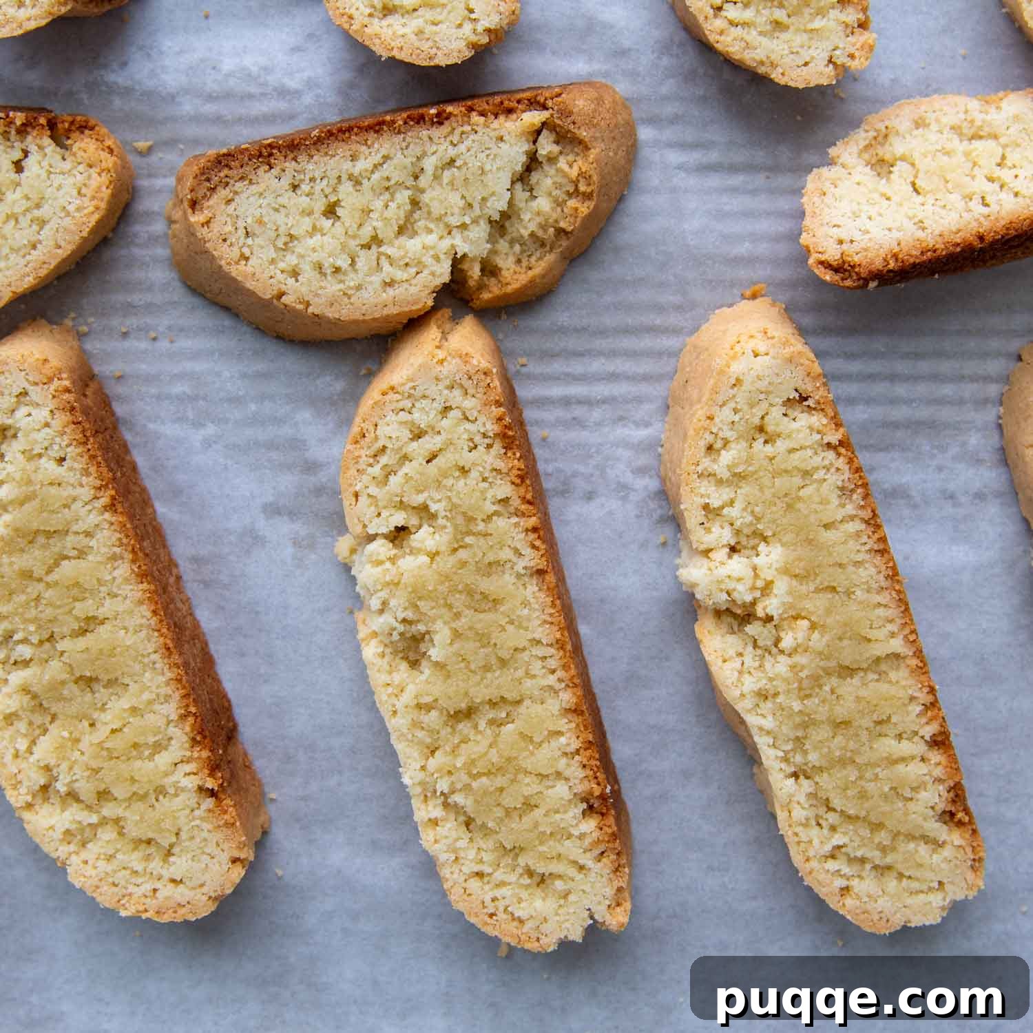 The bisoctti slices laid flat on a baking sheet, showing their slightly underbaked texture before the final crisping bake.