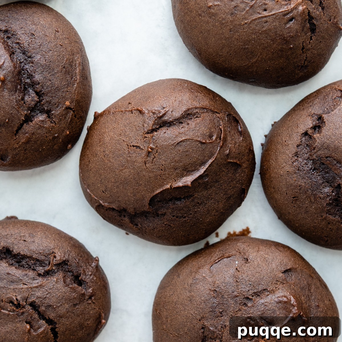 Grandma's Easy Gluten-Free Whoopie Pies 5 Freshly baked gluten-free whoopie pie cookies cooling on a baking sheet, showing their characteristic cracked tops.
