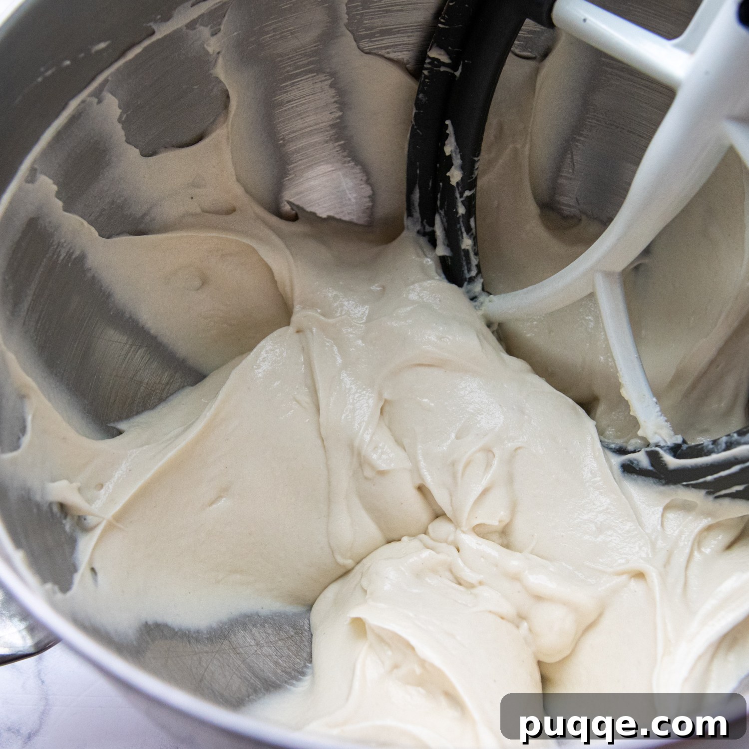 Fluffy Gluten-Free Italian Focaccia Made Easy 4 The soft, pourable gluten-free focaccia dough in a stainless steel mixing bowl, ready for its next stage of preparation.