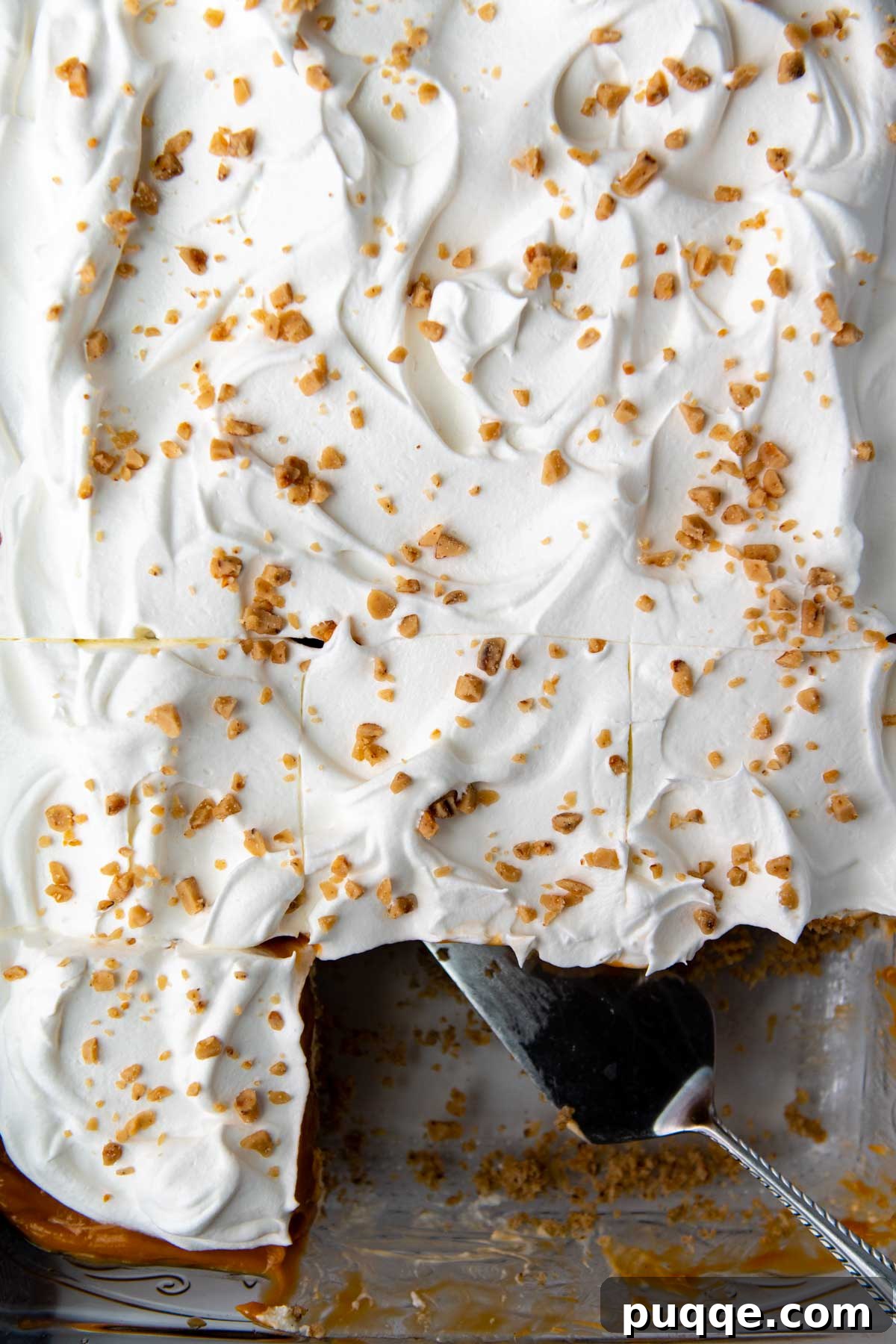 An overhead shot of the butterscotch delight topped with a generous layer of whipped cream and sprinkled with Heath bits.