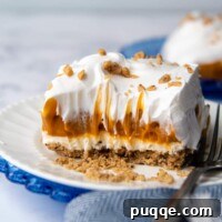 A slice of butterscotch delight on a white plate with a bite taken out
