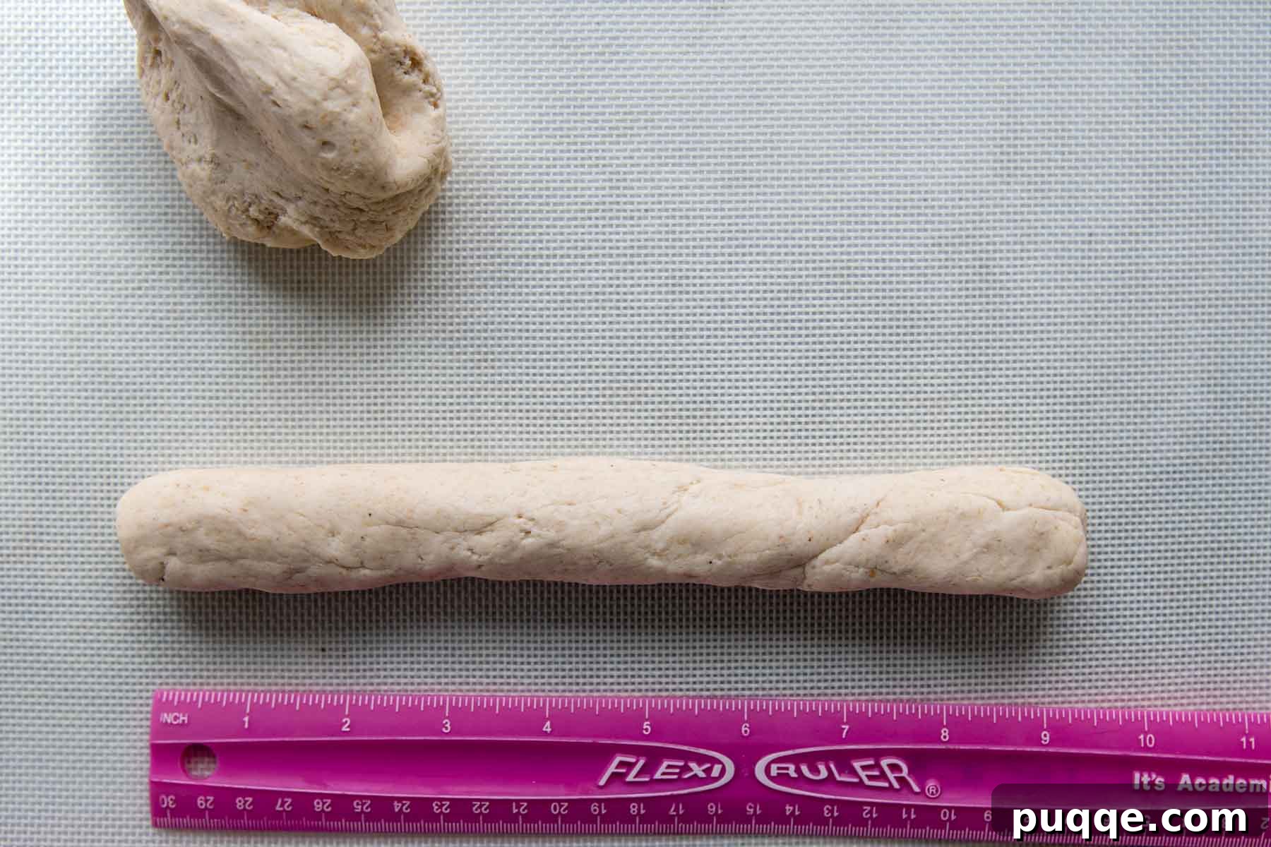 Effortless Soft & Chewy Gluten-Free Bagels 4 Image demonstrating gluten-free bagel dough shaped into a uniform 9-inch rope, ready for forming circles.