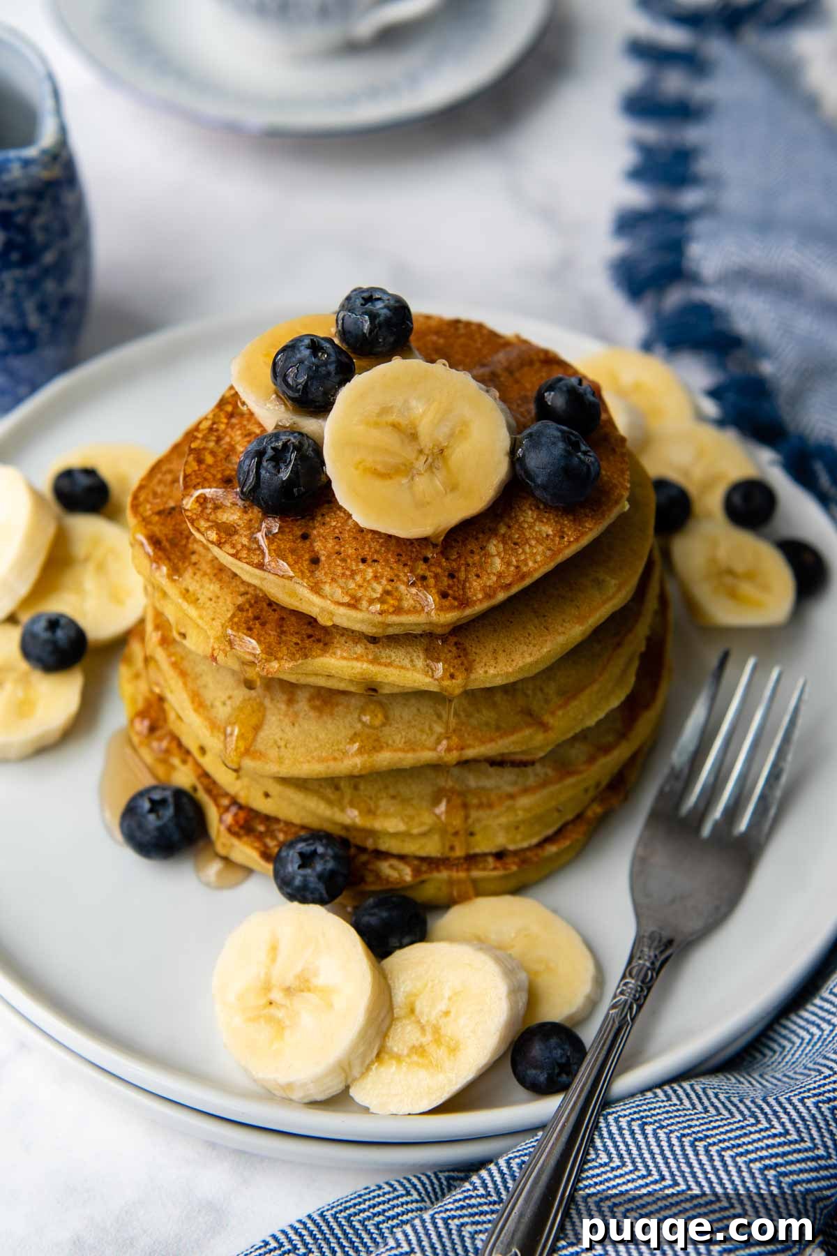 Delicious Gluten-Free Banana Buckwheat Pancakes 3 overhead shot of buckwheat pancakes with blueberries and bananas on top.