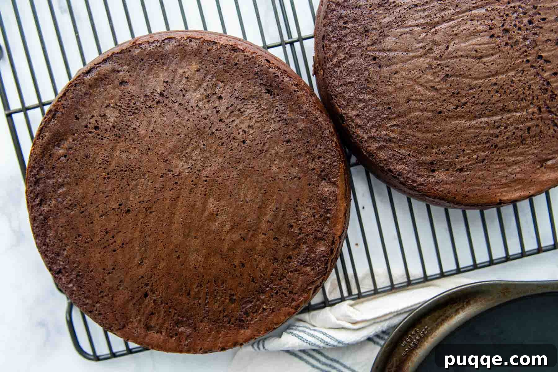 Freshly baked gluten-free chocolate cake layers cooling on a wire rack.