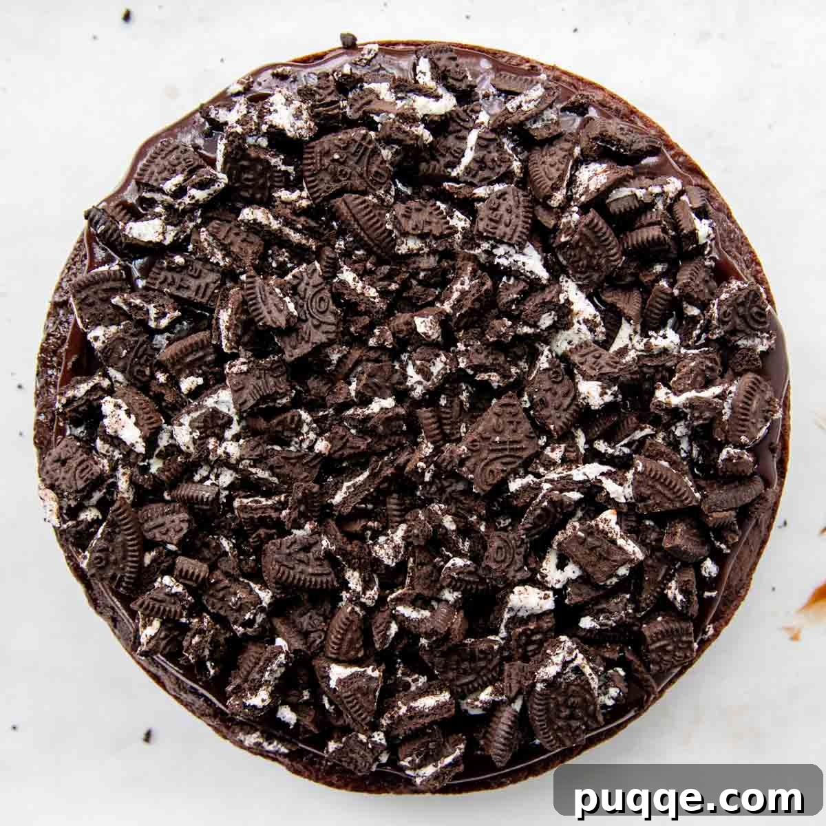 Crushed gluten-free Oreo cookies sprinkled on top of the hot fudge layer on the cake.