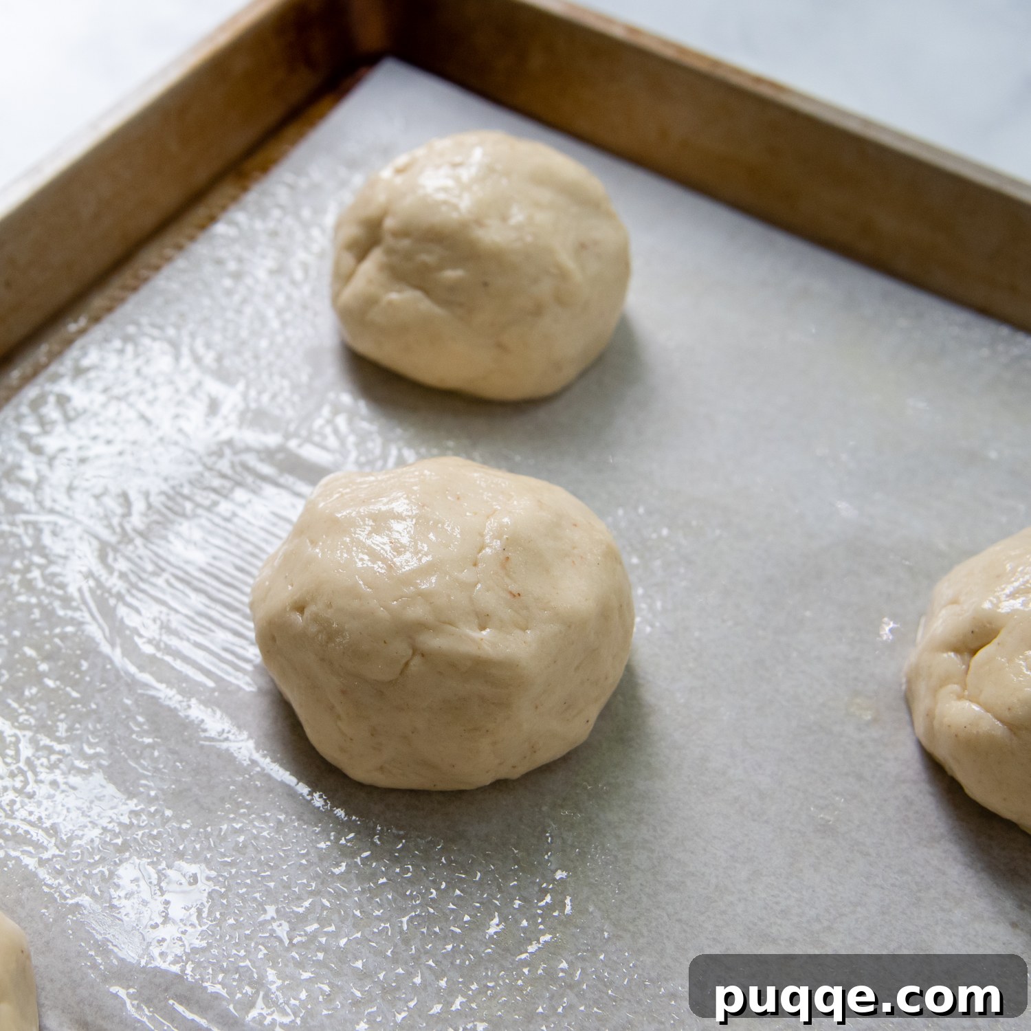 Unbelievably Soft Gluten Free Hamburger Buns No Crumbs 5 Uniformly shaped gluten-free buns neatly arranged on a baking sheet, pre-rise.