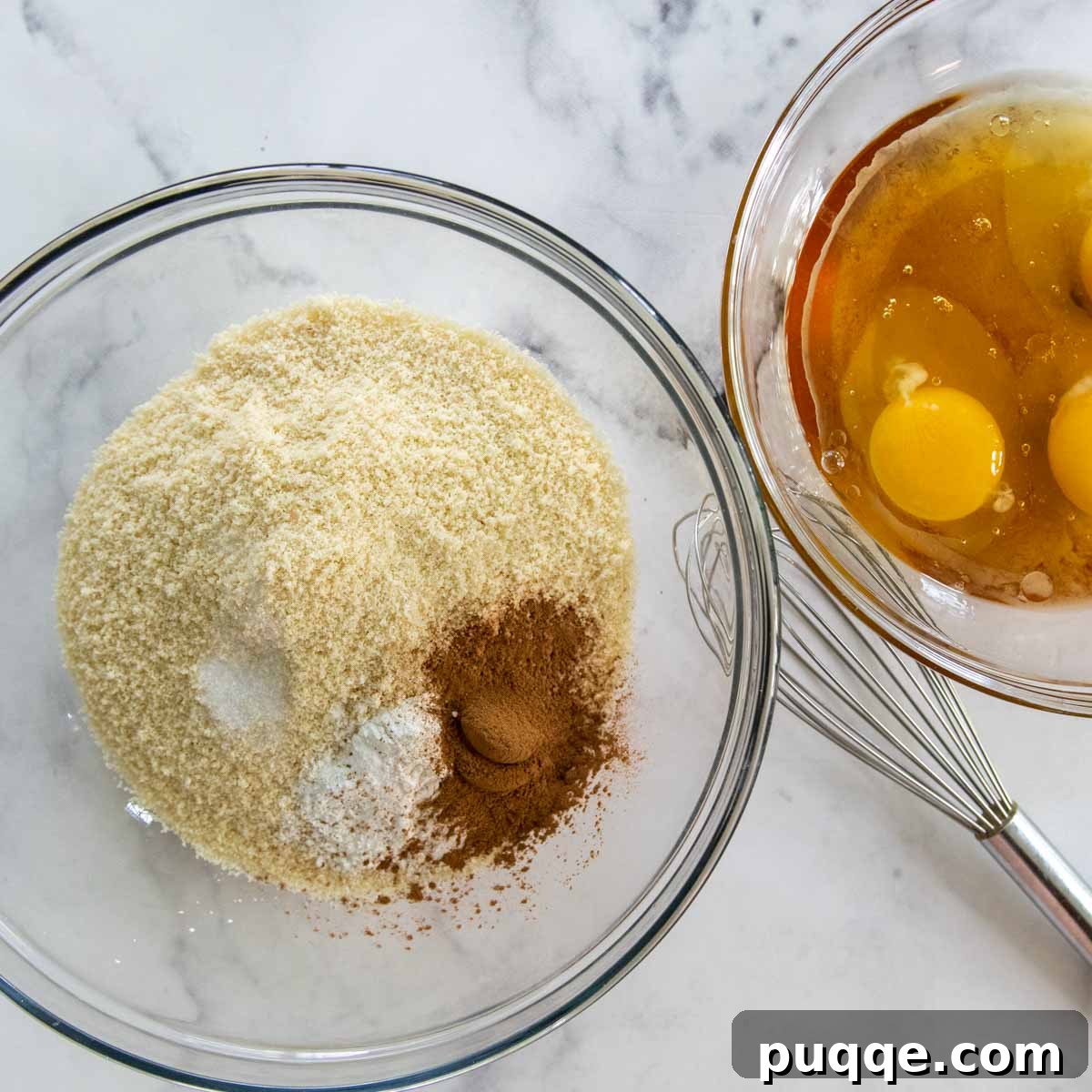 Two bowls, one containing dry muffin ingredients and the other with wet ingredients.
