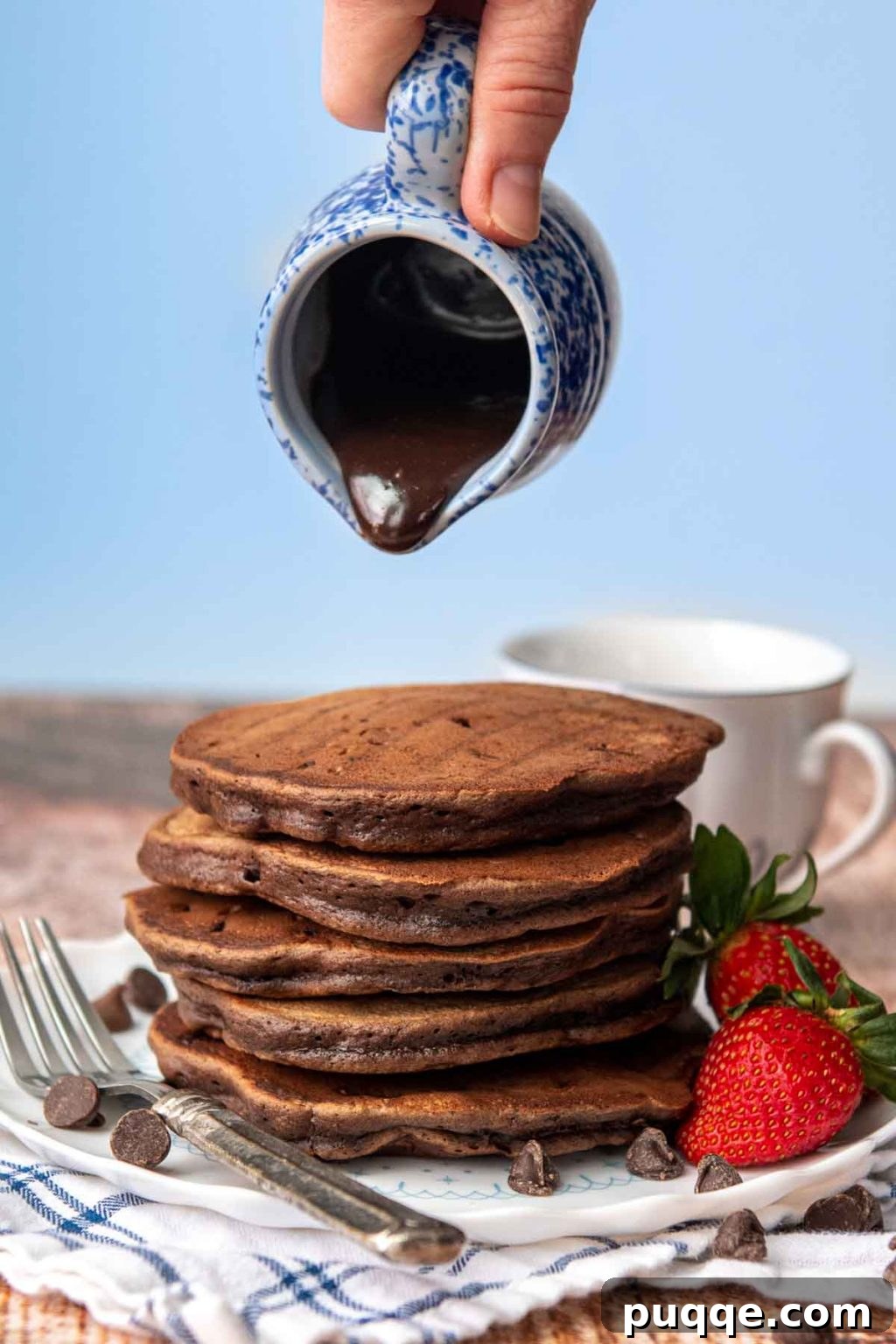 The Ultimate Gluten-Free Syrup Handbook: Top Brands and Effortless Homemade Recipes 5 Rich chocolate syrup about to be drizzled over a stack of fluffy homemade chocolate pancakes.
