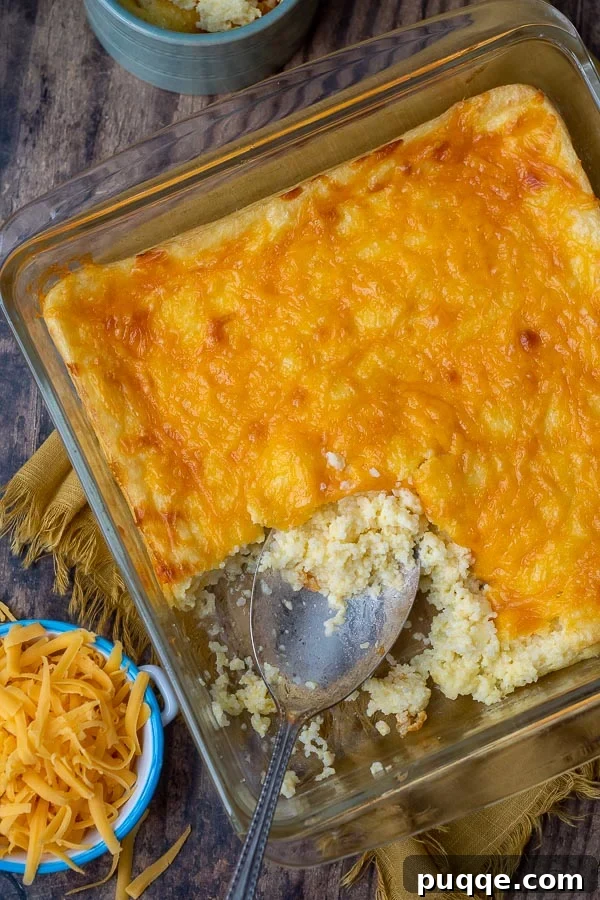 Chicken and Dumplings Pairing Perfection The Best Sides and Those to Bypass 11 Overhead shot of cheese grits casserole with shredded cheese beside it.