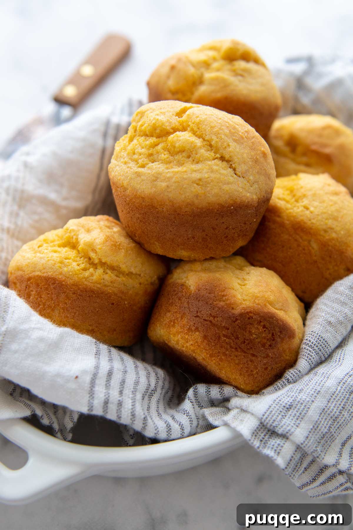 Chicken and Dumplings Pairing Perfection The Best Sides and Those to Bypass 10 A basket of corn muffins lined with a white towel.