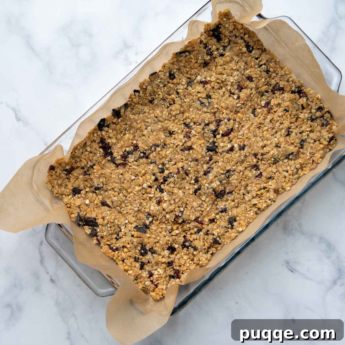 Ultimate Chewy Gluten-Free Chocolate Chip Granola Bars 6 Unbaked granola bar mixture pressed into a baking dish, ready for the oven.