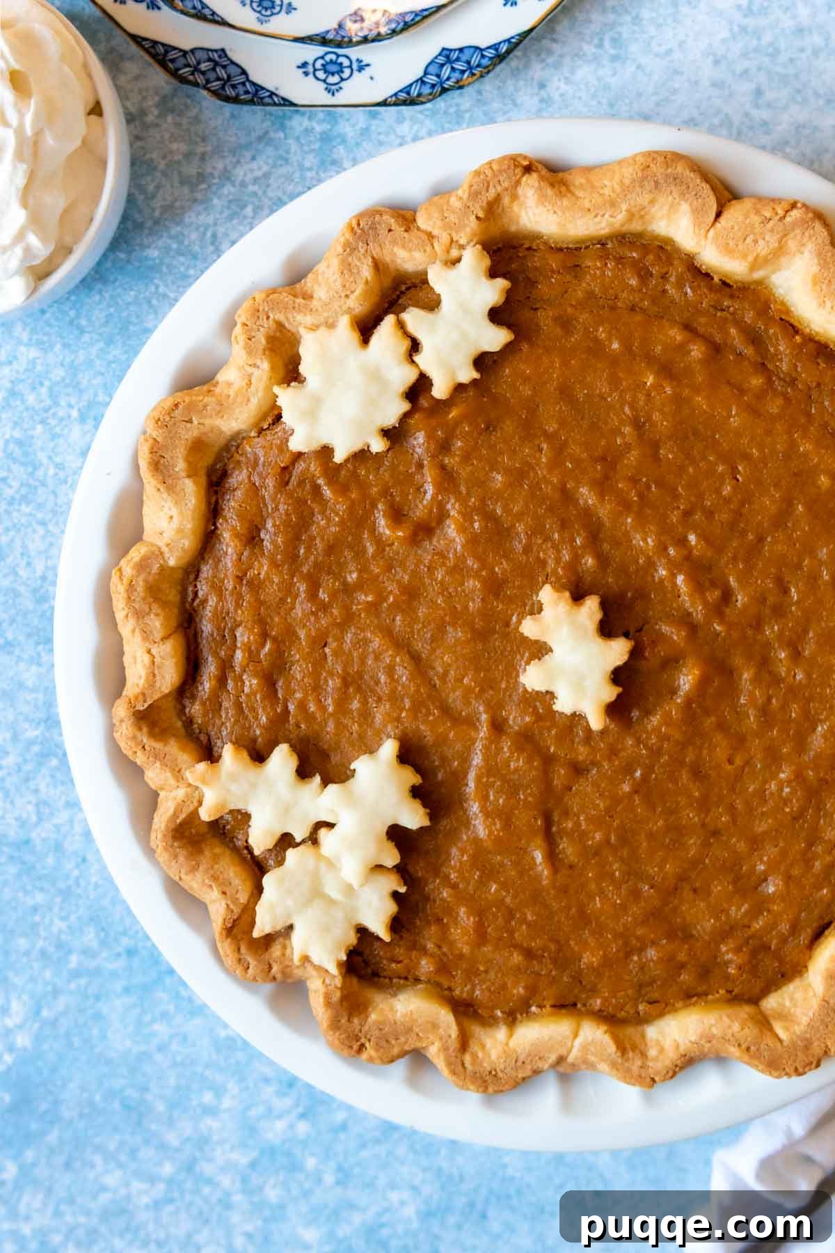 Southern Soul Gluten-Free Sweet Potato Pie with a Flaky Golden Crust 2 overhead shot of sweet potato pie on a blue background.