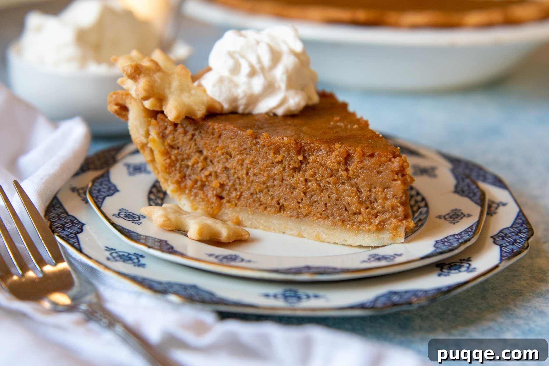 Southern Soul Gluten-Free Sweet Potato Pie with a Flaky Golden Crust 9 a slice of pie on a plate with whipped cream on top and the whole pie in the backgroud.