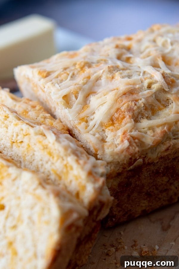 A close-up shot of the golden, savory top of quick cheese bread, hinting at its cheesy goodness.