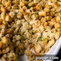 Close up of the inside of moist gluten-free stuffing, showcasing its texture and ingredients.