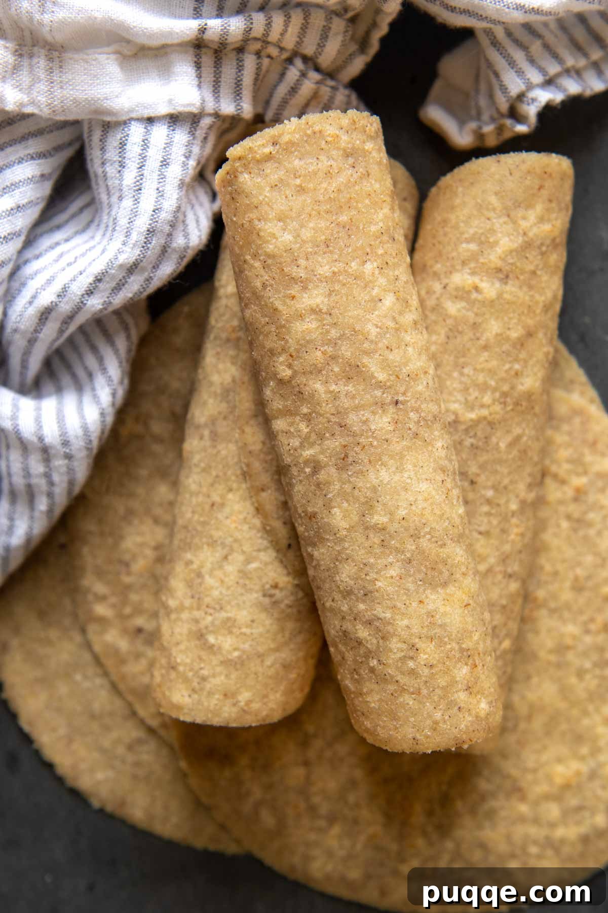 A neat stack of soft, flexible almond flour tortillas, perfectly rolled and ready for enjoyment.