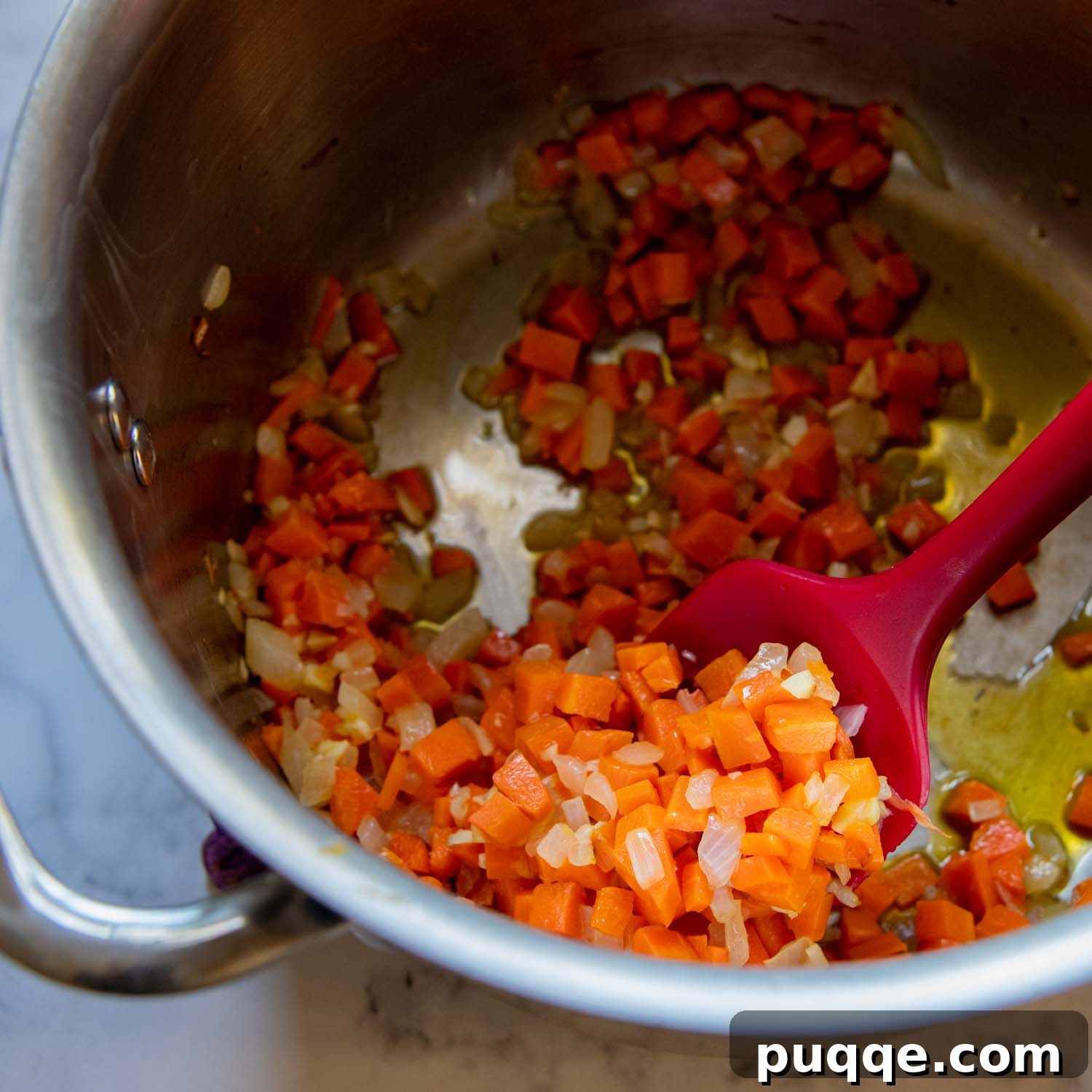Amazing Gluten-Free Tomato Soup From Your Pantry 3 Diced onions and carrots cooking in a pot with melted butter.
