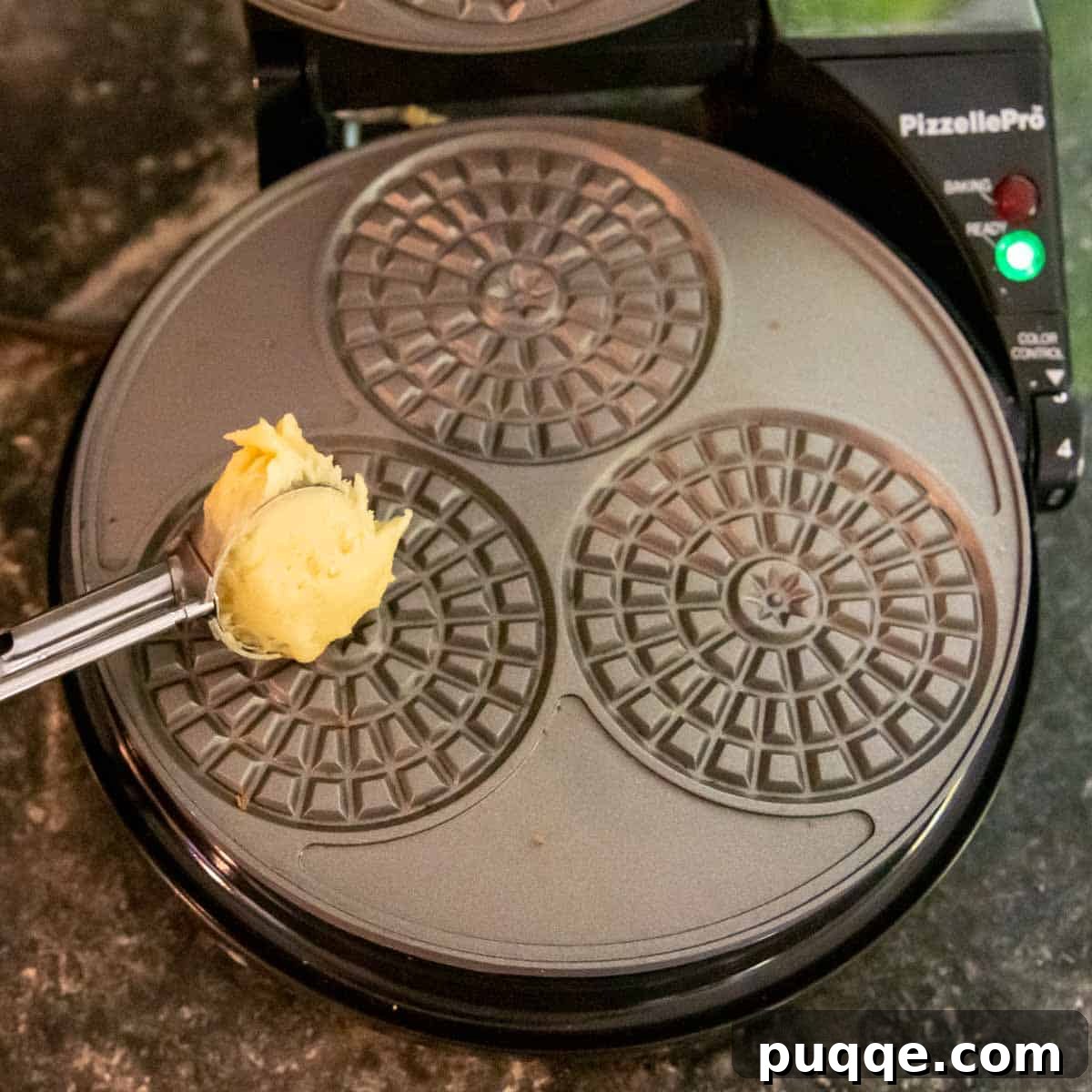 Crispy Gluten-Free Italian Pizzelle Cookies 4 A small dollop of pizzelle batter being dropped onto a hot pizzelle iron.