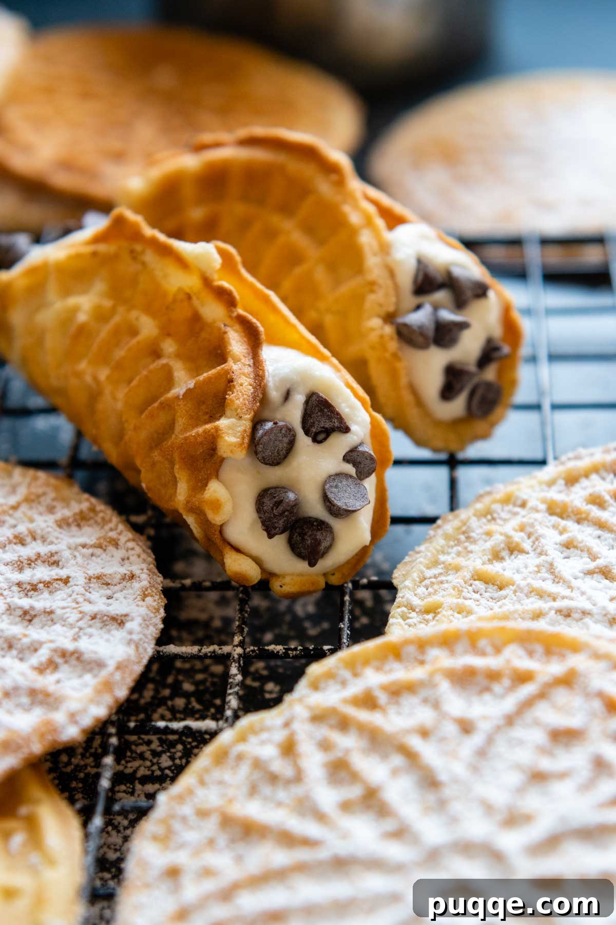 Crispy Gluten-Free Italian Pizzelle Cookies 6 An inviting image of golden-brown pizzelles expertly shaped into cannoli shells, ready for filling.