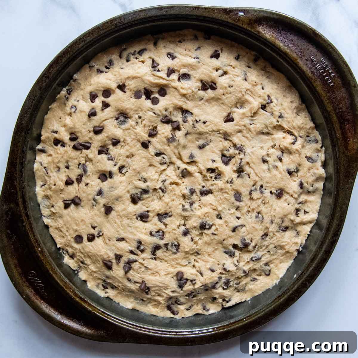 Irresistibly Soft Chewy and Moist Gluten Free Cookie Cake 4 the unbaked cake in a pan.