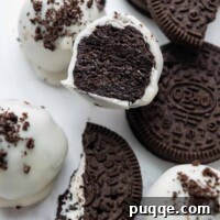 A gluten-free Oreo ball, cut in half to show its creamy center, presented beautifully.