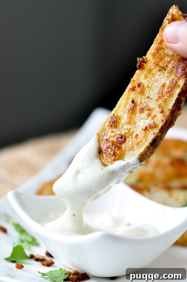 The Ultimate Guide to 50+ Easy Salisbury Steak Sides 11 a roasted ranch potato being dipping into ranch dressing