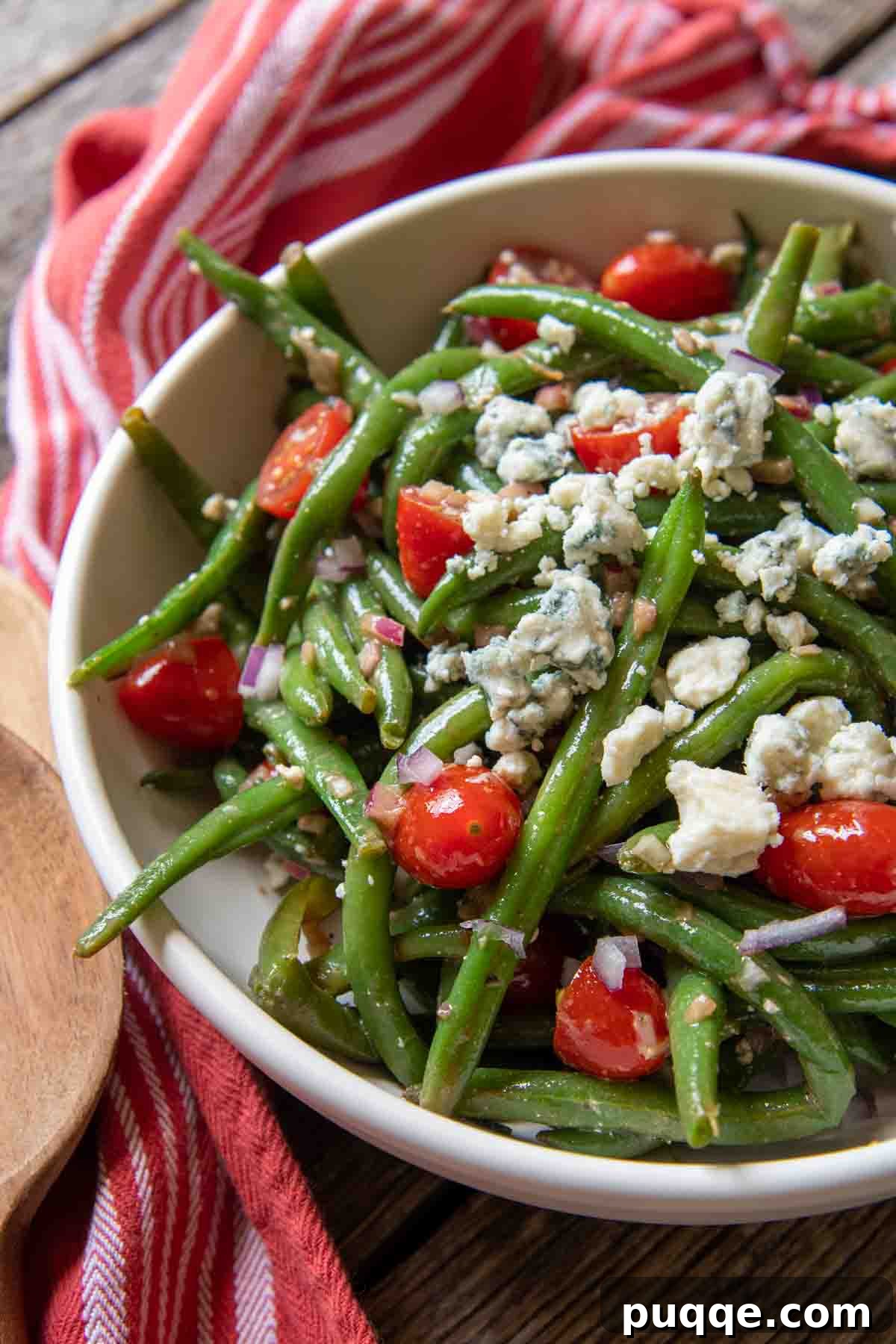 The Ultimate Guide to 50+ Easy Salisbury Steak Sides 12 a close up of a serving bowl of beans, blue cheese and tomatoes