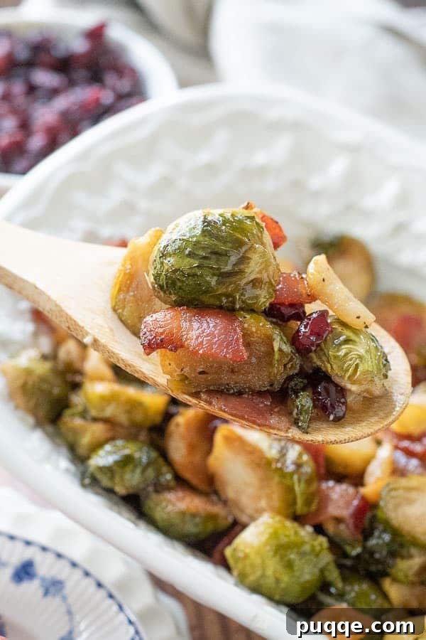 The Ultimate Guide to 50+ Easy Salisbury Steak Sides 10 a wooden spoon lifting out a scoop of bacon brussels sprouts