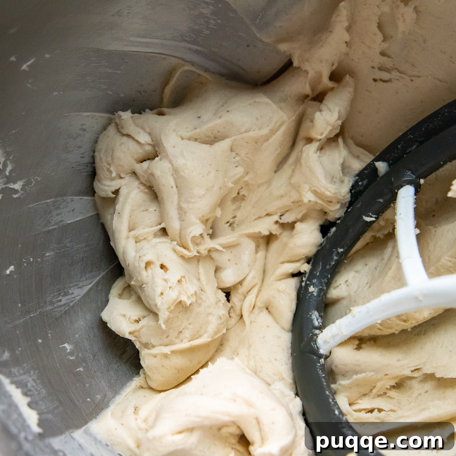 Cloud-Like Gluten-Free Cinnamon Rolls 4 Gluten-free cinnamon roll dough in a stand mixer bowl after mixing, showing a stiff but sticky consistency.