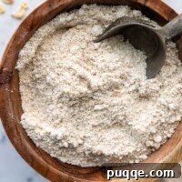 Mastering Fluffy Oat Flour: From Scratch to Smart Substitutes and Perfect Portions 4 A bowl of oat flour with a scoop in it.