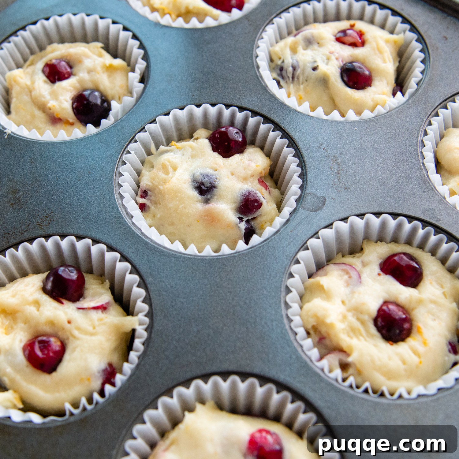 Ultimate Gluten-Free Cranberry Orange Muffins 5 Gluten-free cranberry orange muffin batter perfectly portioned into muffin tins, ready for baking.