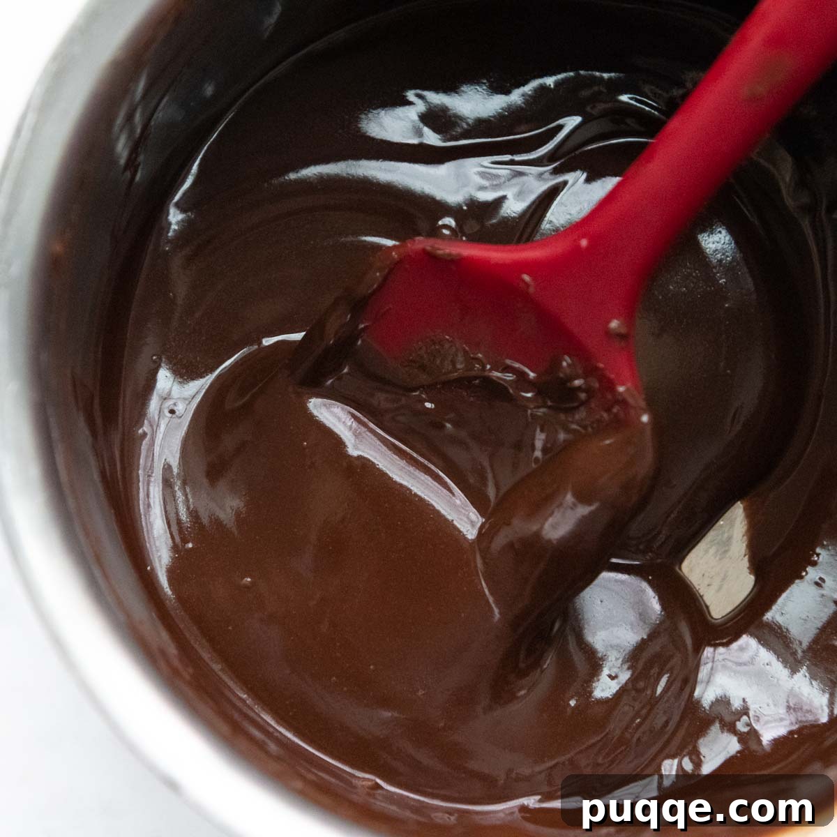 Effortless Gooey Gluten Free Brownie Cookies 3 Melted butter and chocolate chips create a glossy, dark mixture in a small saucepan, ready to be incorporated into the cookie dough.