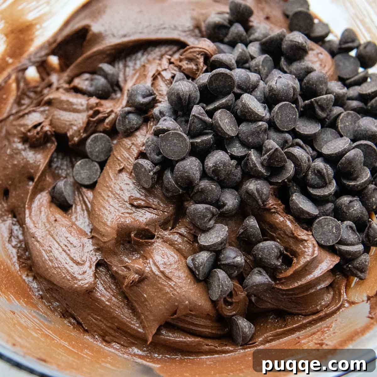 Effortless Gooey Gluten Free Brownie Cookies 5 Additional semi-sweet chocolate chips are being stirred into the rich, dark brownie cookie dough, ensuring chocolatey goodness throughout.