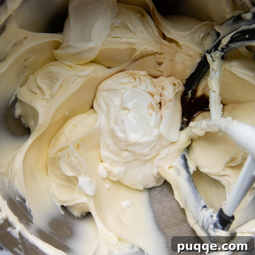 Velvet Smooth Gluten-Free Oreo Cheesecake Bliss 5 Creamy cheesecake filling being mixed in a bowl, ready for the gluten-free Oreo crust.