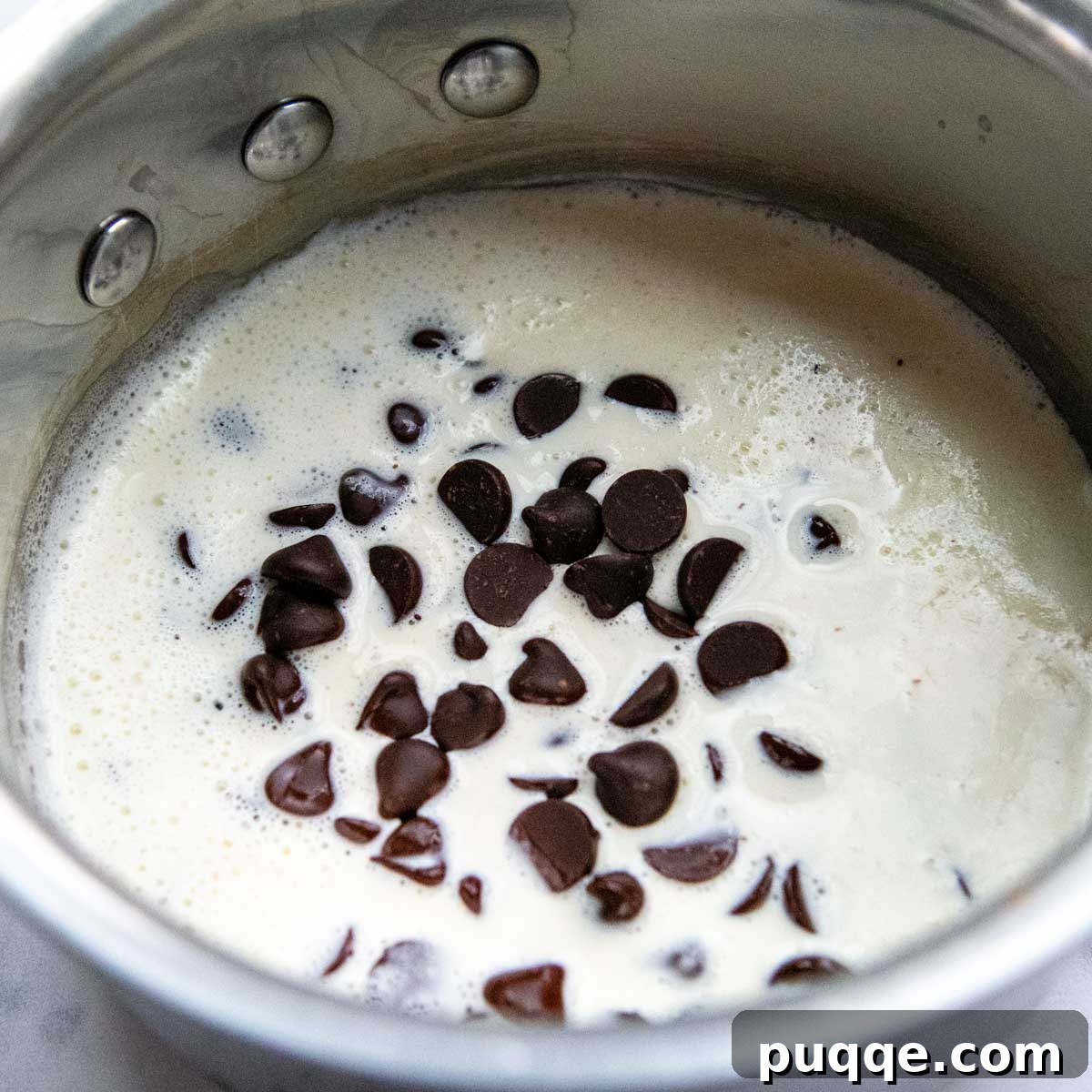 Velvet Smooth Gluten-Free Oreo Cheesecake Bliss 8 Chocolate chips melting in warm heavy cream for the ganache topping.