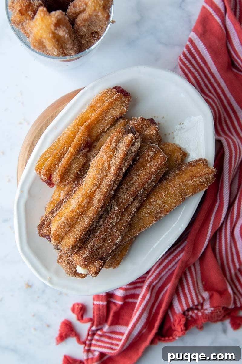 overhead shot of gluten free churros on a white plate with a red dish towel next to it