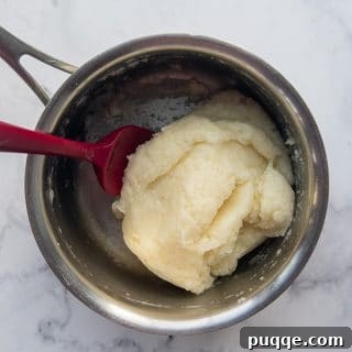 a ball of gluten free churro dough in a saucepan