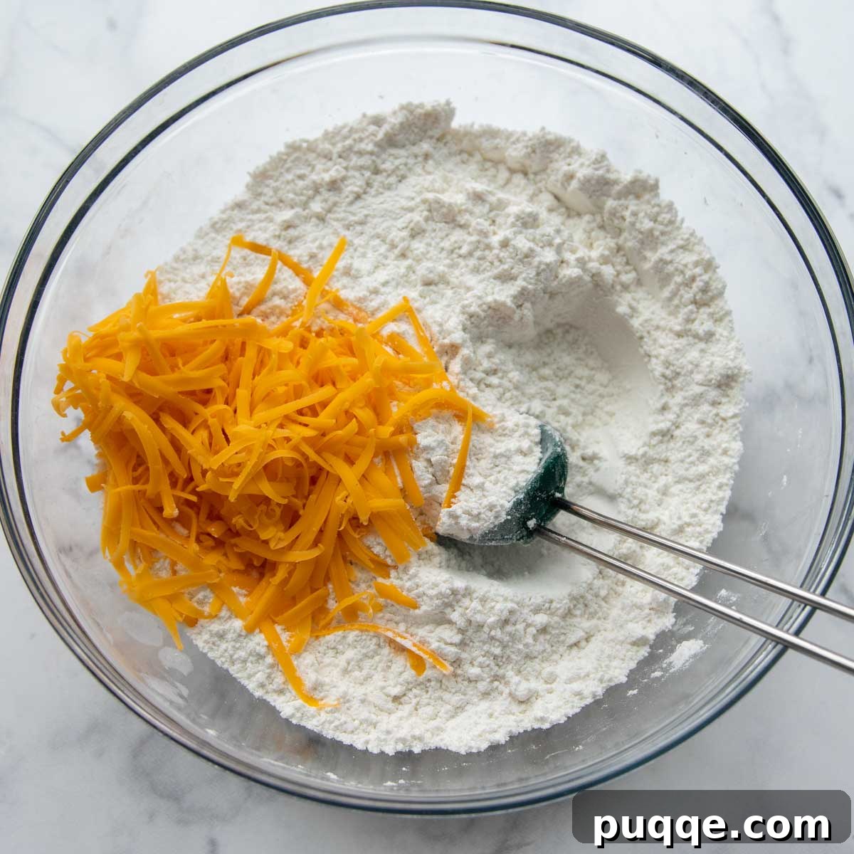 Quick Cheesy Gluten Free Beer Bread 3 cheese being mixed into dry ingredients.
